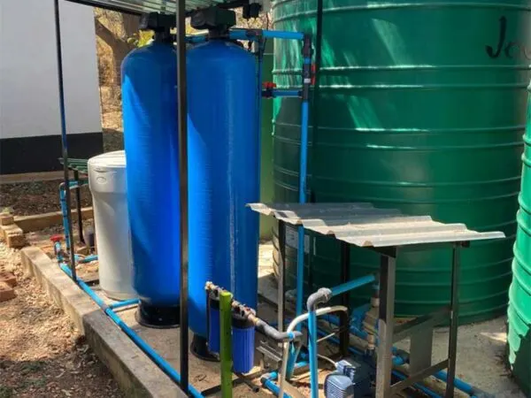 Water softener vessels beside a storage tank