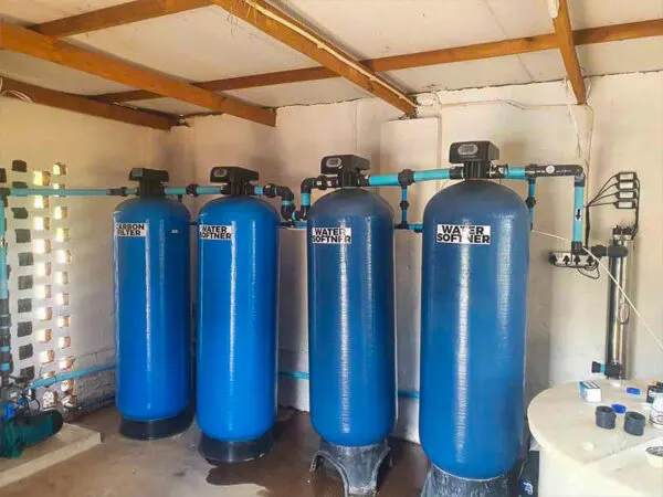 Row of blue filtration vessels indoors